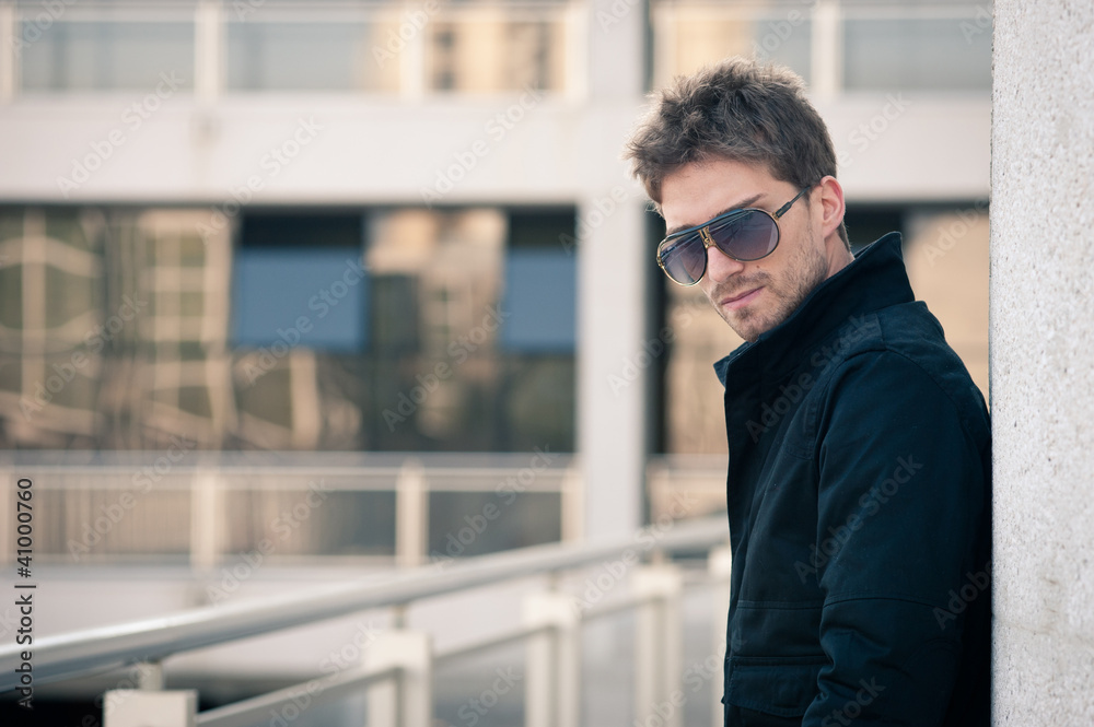 Young man portrait with building background.
