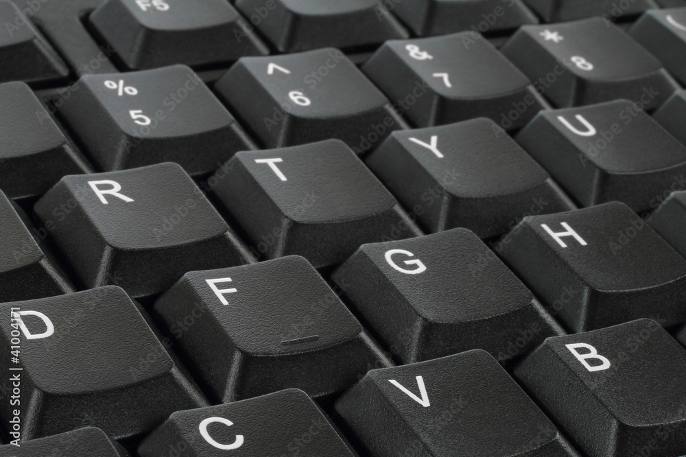 Black keyboard keys background with white letters Black keyboard keys background with white letters