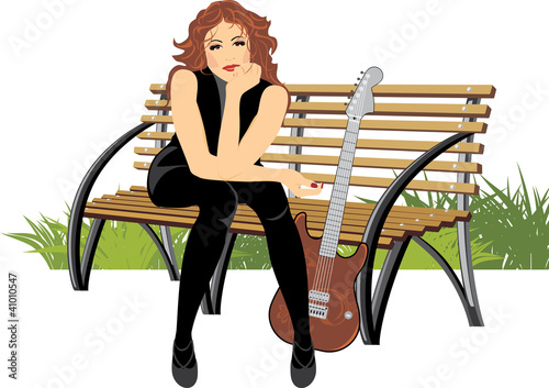 Beautiful woman sitting with guitar on the wooden bench