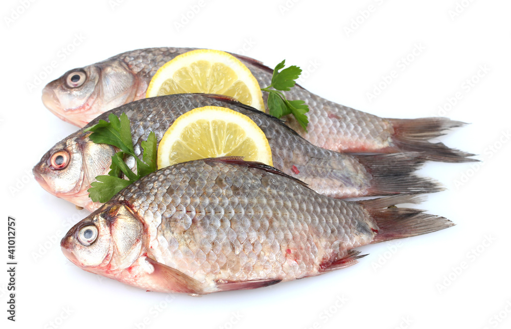 Fresh fishes with lemon and parsley isolated on white Fresh fishes with lemon and parsley isolated on white