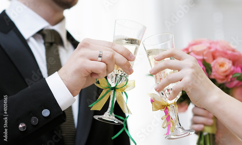 Bride and groom holding champagne glasses