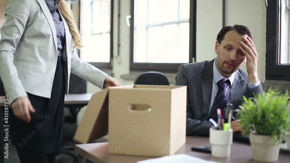 Shocked young businessman is getting fired by his boss