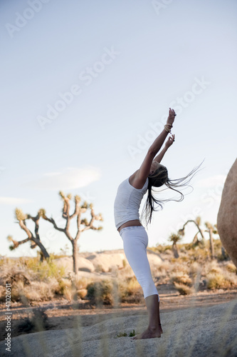 Yoga Shakti wild fit woman in free form movement in the desert.  photo