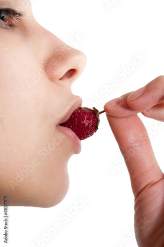 Image of tasty strawberry in female mouth - isolated on white