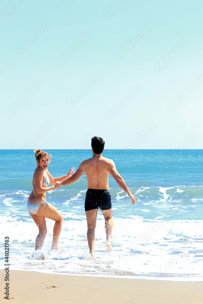 beautiful couple posing on the sea coast