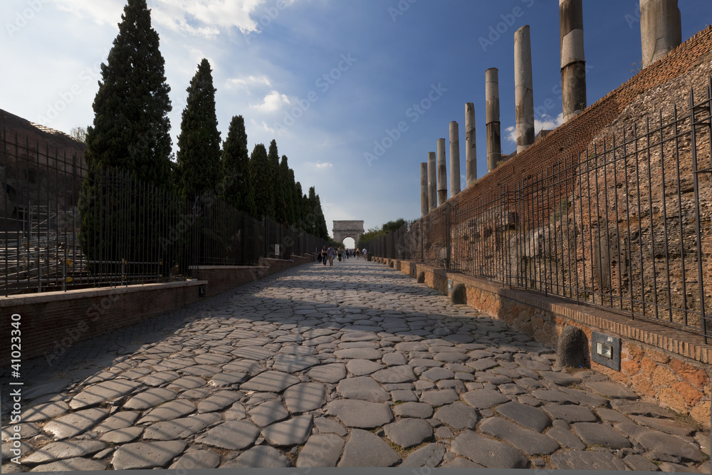 ancient stone road leading to colosseum in Rome, Italy