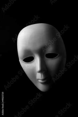 White opera mask on black background
