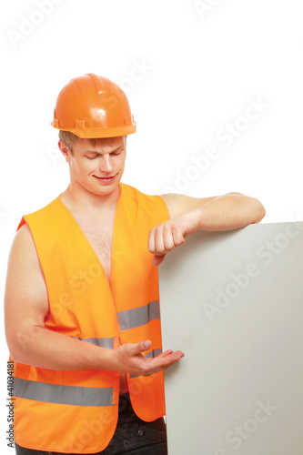 Constructor in hardhat pointing at banner, isolated on white