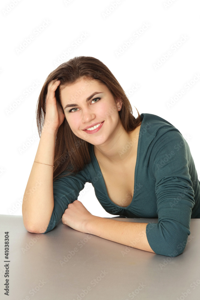 A young woman sitting at the desk isolated on white background A young woman sitting at the desk isolated on white background