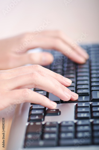 Hands typing on the keyboard © Elnur