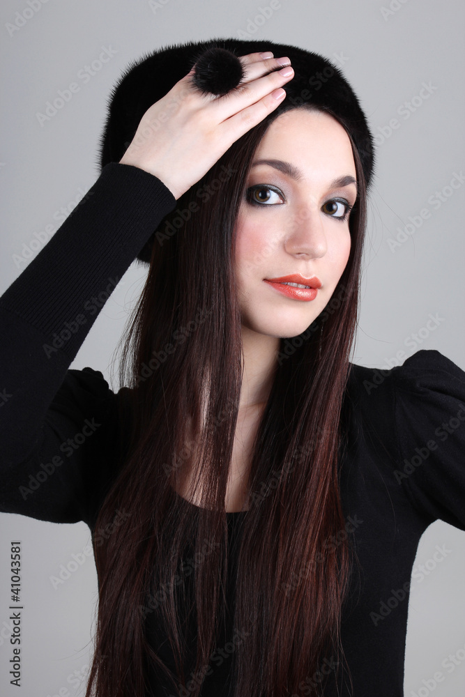 Fototapeta premium Happy woman in black fur hat