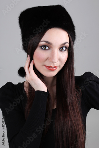 Happy woman in black fur hat
