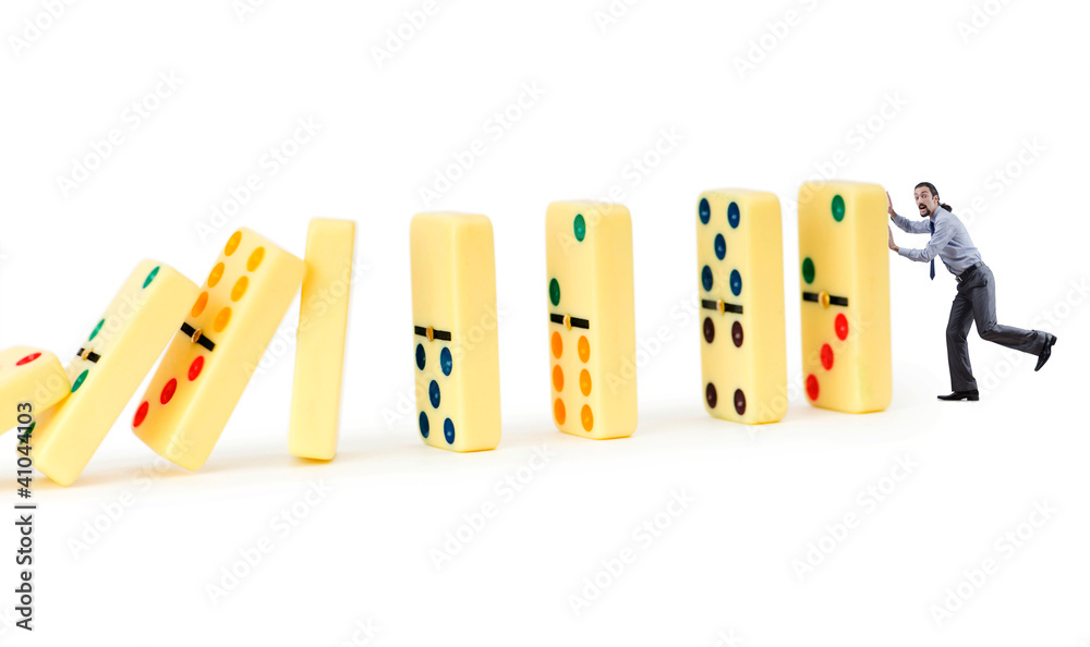 Businessman and dominoes isolated on the white Businessman and dominoes isolated on the white