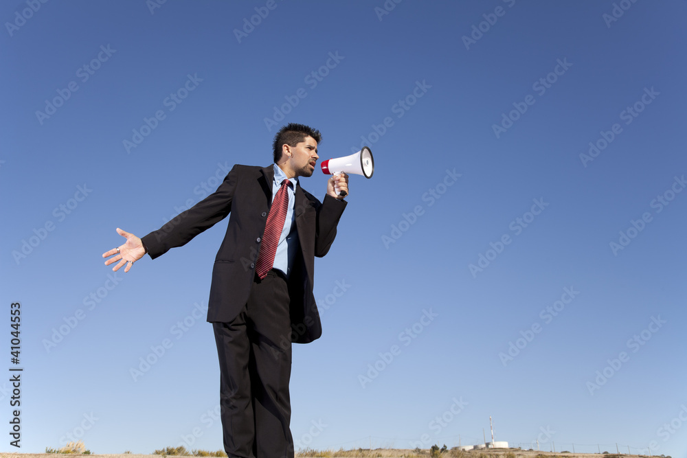 Businessman speaking with a megaphone Businessman speaking with a megaphone