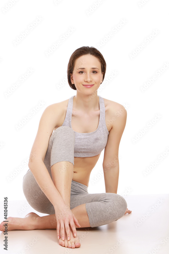 A young sportive girl sitting, isolated on white A young sportive girl sitting, isolated on white
