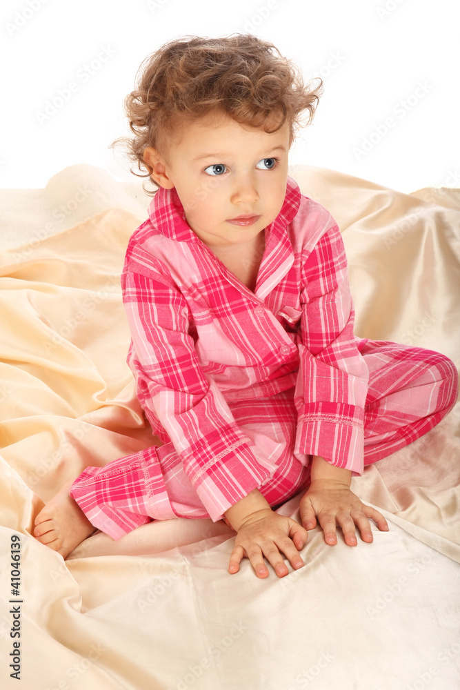 Beautiful baby on the bed isolated on white background Beautiful baby on the bed isolated on white background