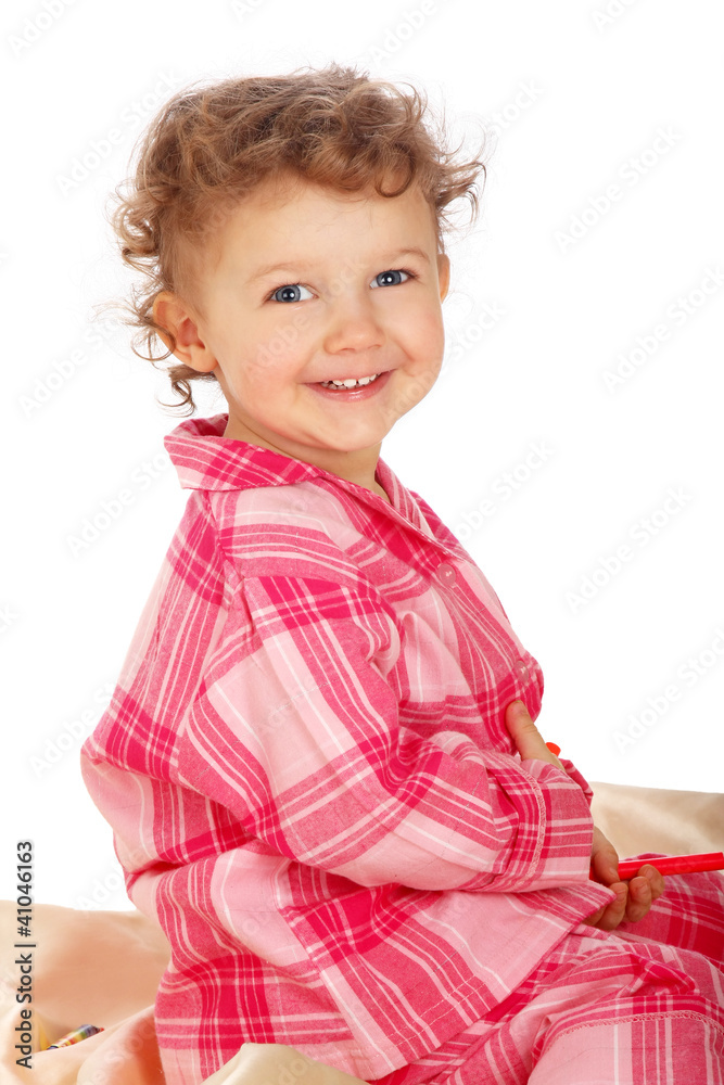 Beautiful baby on the bed isolated on white background Beautiful baby on the bed isolated on white background