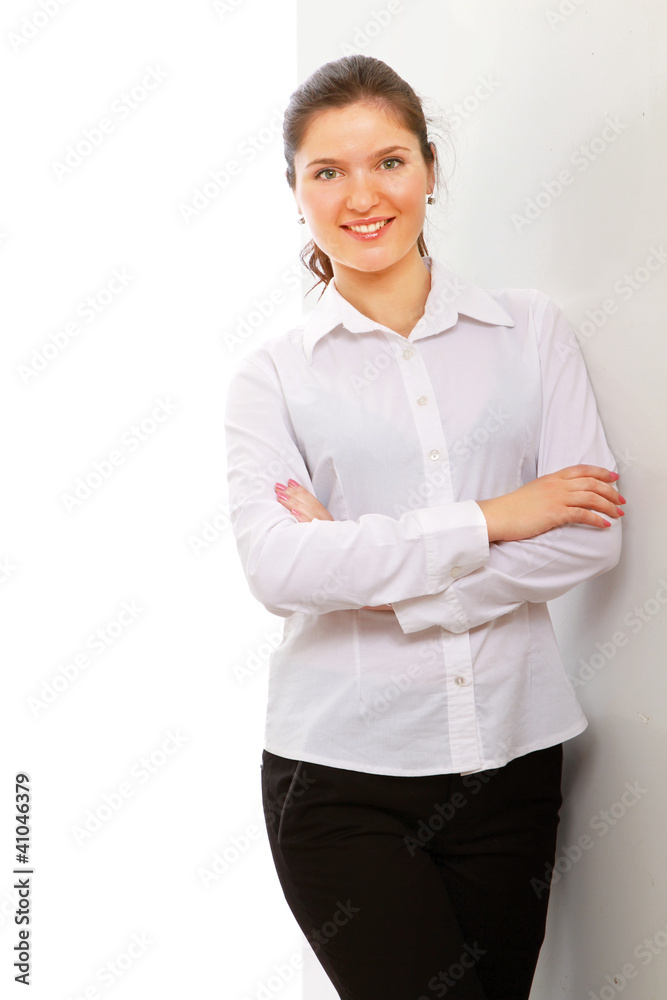 A businesswoman standing near the wall, isolated on white A businesswoman standing near the wall, isolated on white