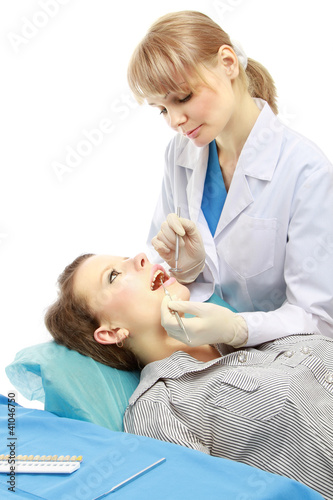 Dentist examining patient's teeth isolated