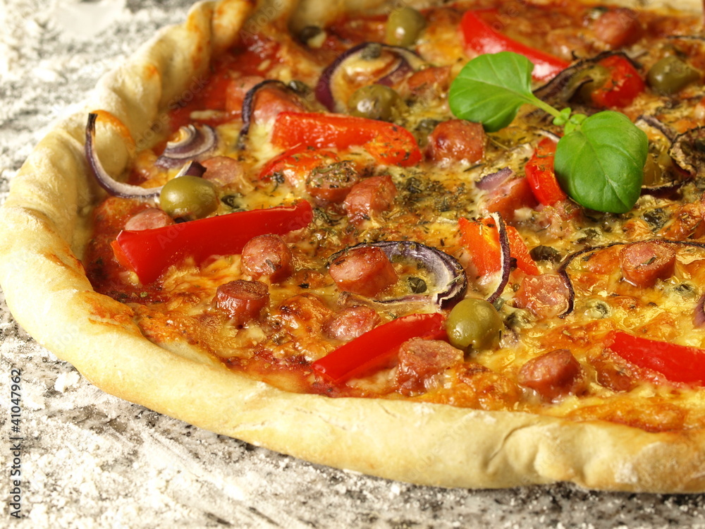 Close-up of pizza with vegetables and sausages