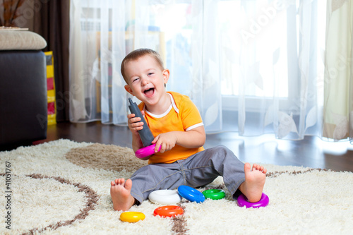 funny child playing with co...