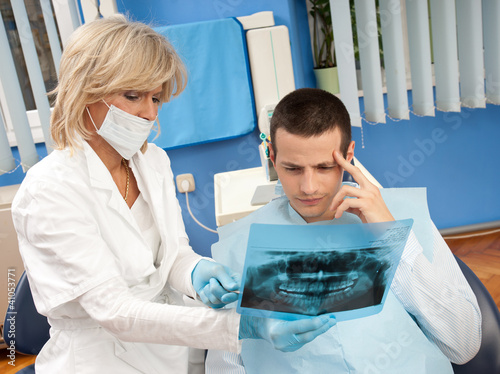 woman dentist with male patient