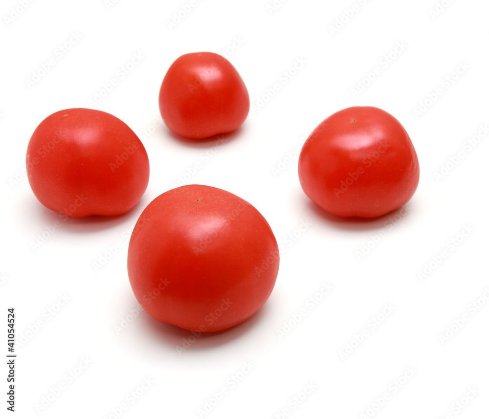 Red tomatos on white background.