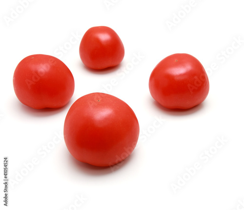 Red tomatos on white background.