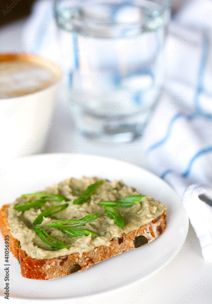 Fish pâté or spread with scallions on whole grain slice of bread Fish pâté or spread with scallions on whole grain slice of bread