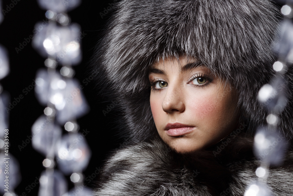 Beautiful young girl in fur clothes. Studio shot Beautiful young girl in fur clothes. Studio shot