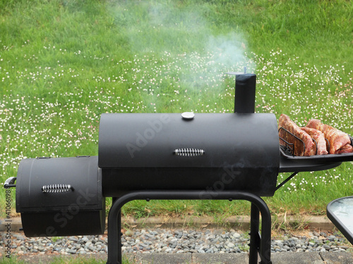 Fotografija Backyard barbequing on a charcoal smoker