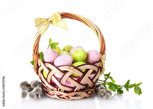 basket with Easter eggs and pussy-willow twigs isolated on white