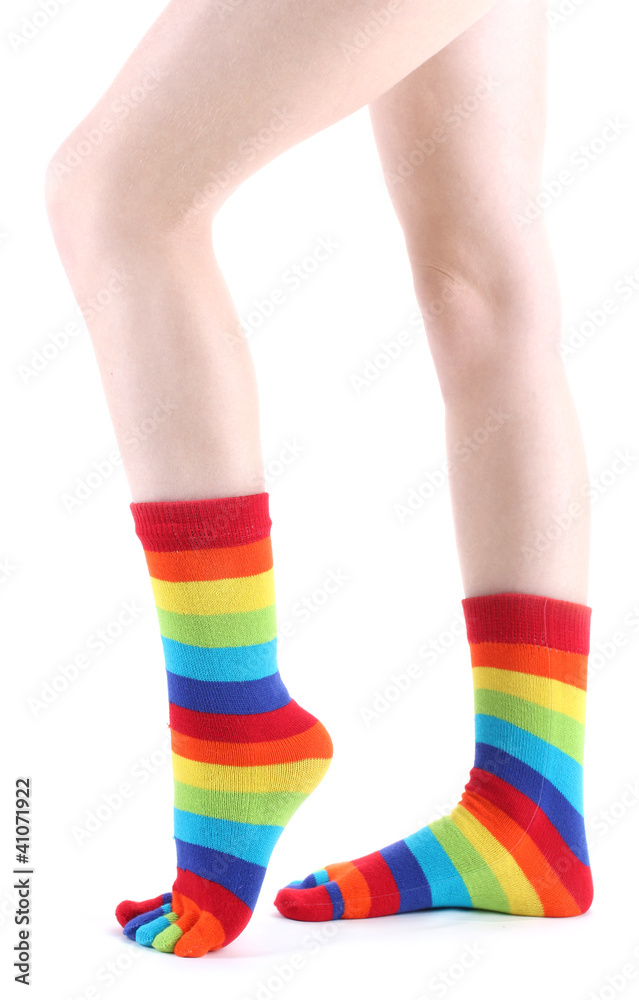 female legs in colorful striped socks isolated on white