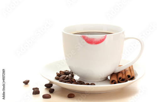 cup of coffee with lipstick mark beans and cinnamon sticks