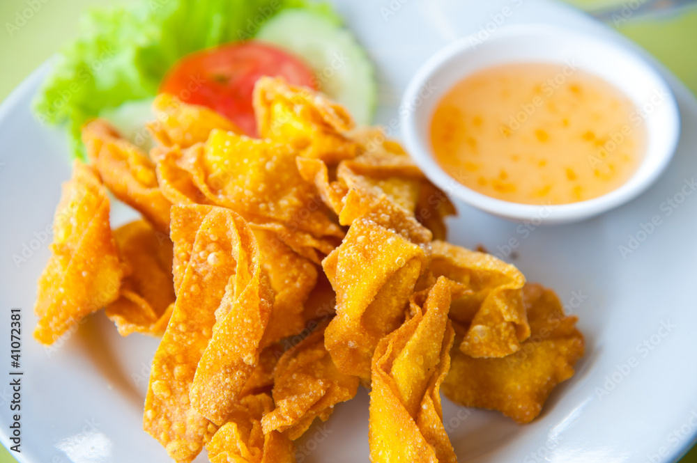 Deep Fried Wonton on white dish with plum sauce Deep Fried Wonton on white dish with plum sauce