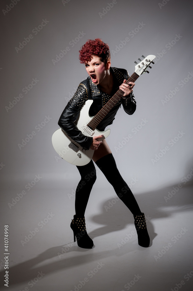 Fototapeta premium Young rock chick singer with guitar