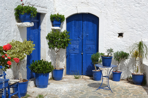 Typical greek courtyard with blue flower pots in Piskopiano. © dutchlight