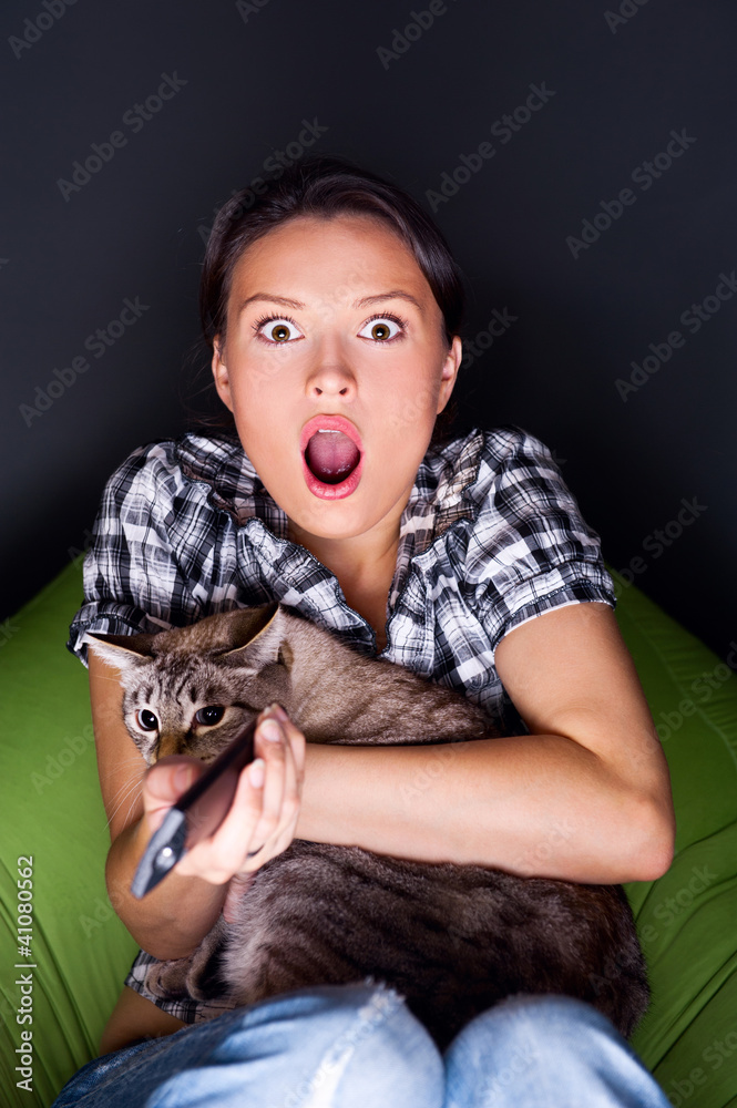 Fototapeta premium Woman sitting in her beanbag and embracing her cat