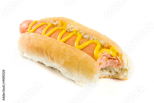 Hot dog with missing bite and mustard over white
