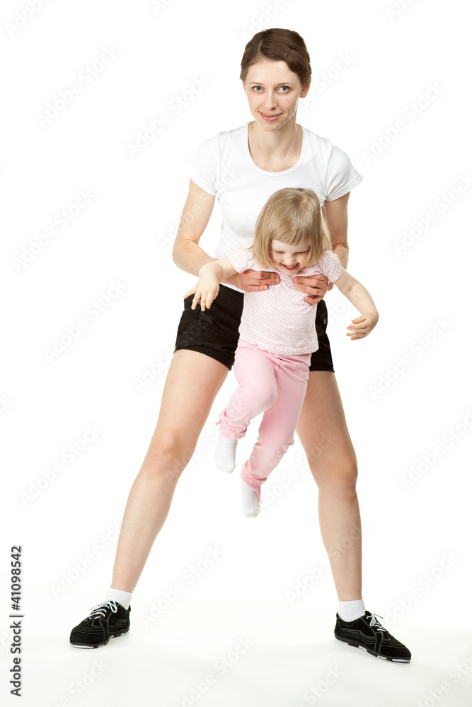 Happy young mother doing sport with little daughter Happy young mother doing sport with little daughter