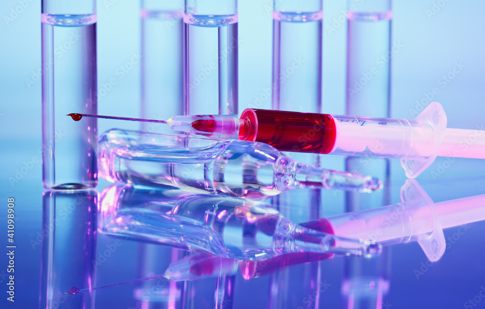 Ampoule and syringe macro still life on blue purple Ampoule and syringe macro still life on blue purple