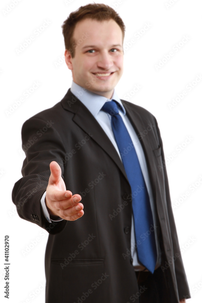 A businessman giving a hand, focus on his hand A businessman giving a hand, focus on his hand