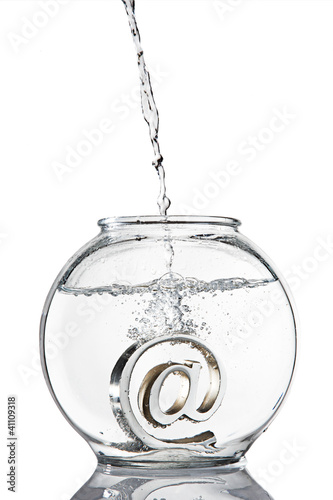 Schilderij op canvas At symbol paperweight in a fishbowl with water pouring in