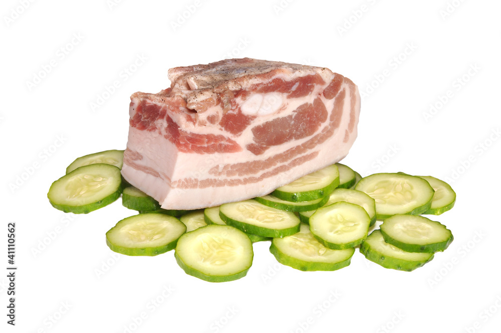 The piece of pork  on cucumbers