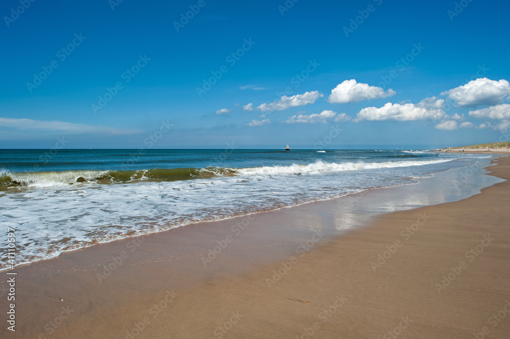 Trawler fishing at sea under a blue sky