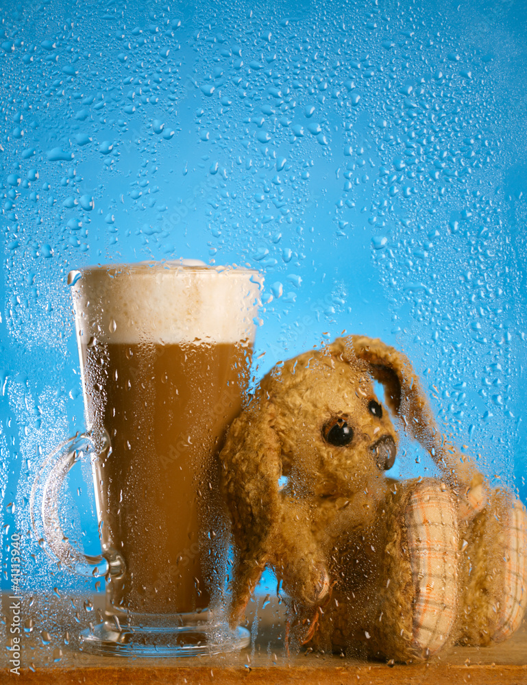 bunny and coffee latte behind rainy window, shallow dof on glass - obrazy, fototapety, plakaty 
