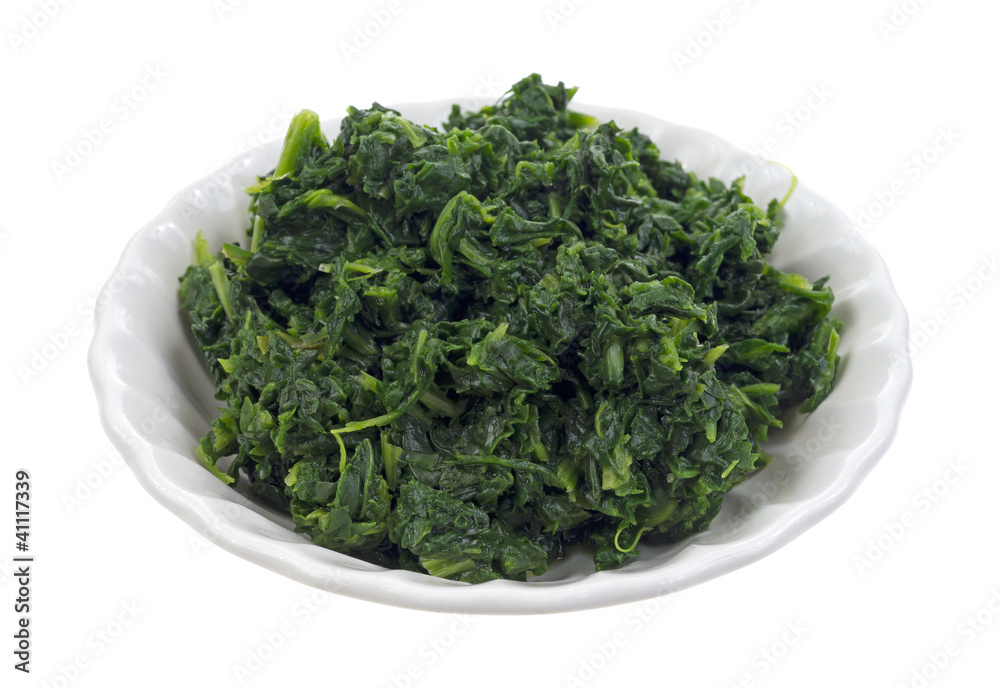 Small serving of chopped spinach in bowl Small serving of chopped spinach in bowl