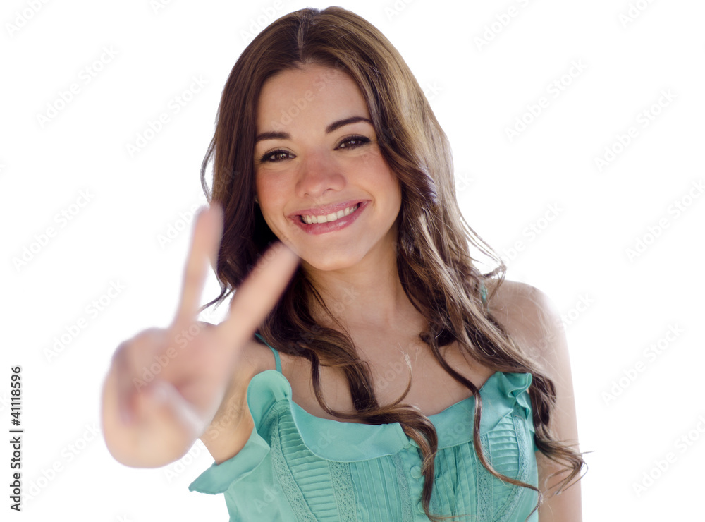 Young woman giving a peace sign Young woman giving a peace sign