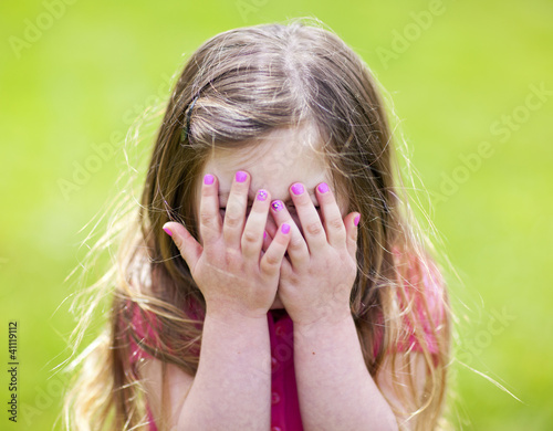 Adorable girl playing peek a boo photo