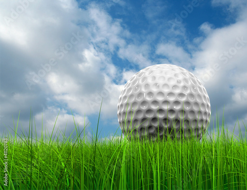Conceptual golf ball in grass over a blue sky